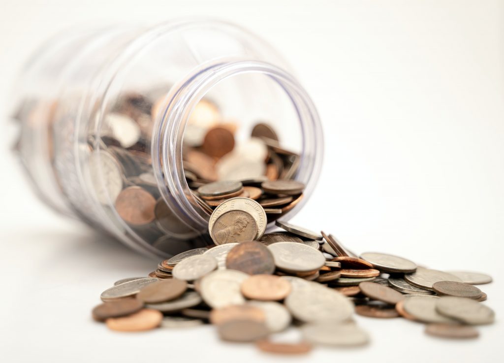 Money spilling from a jar